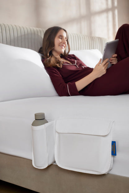 Woman using organic cotton fitted sheet with side storage pockets